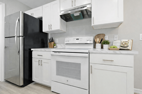 Naples apartment for rent - A modern kitchen with white appliances and cabinets.
