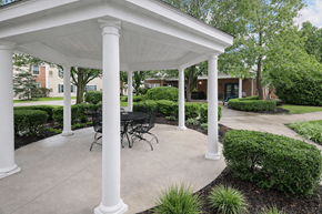 Hilliard apartment for rent - A white covered patio with a table and chairs.