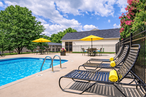 Concord apartment for rent - A pool area with a black fence and yellow umbrellas.