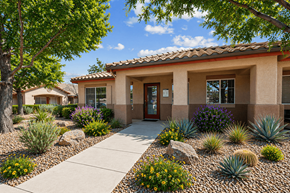 Henderson apartment for rent - A house with a red tile roof and a front yard with a rock and plants.