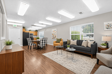 West Jordan apartment for rent - A well-lit living room with a variety of furniture and decor.