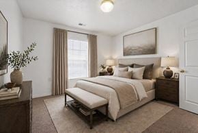 West Jordan apartment for rent - A bedroom with a large bed and a painting on the wall.