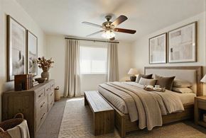 Cedar City apartment for rent - A bedroom with a large bed and a ceiling fan.