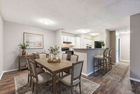 Charlotte apartment for rent - A dining room with a wooden table and chairs.