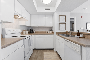 Jacksonville apartment for rent - A kitchen with white cabinets and a beige countertop.