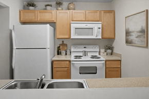 Marion apartment for rent - A kitchen with a white refrigerator, a white microwave, a white stove, and a white oven.