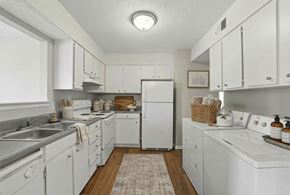 Jonesboro townhouse for rent - A white kitchen with a refrigerator, sink, and oven.