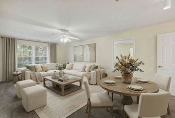 Atlanta apartment for rent - A well-lit living room with a dining table set for four.