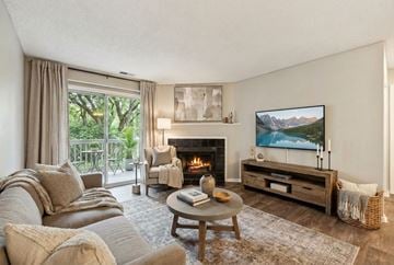 Charlotte apartment for rent - A living room with a fireplace and a painting on the wall.