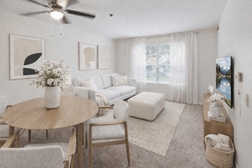Hilliard apartment for rent - A living room with a round table and chairs, a sofa, and a television.