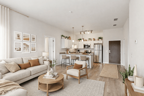 Prior Lake apartment for rent - A modern living room with a white sofa, wooden coffee table, and a kitchen in the background.