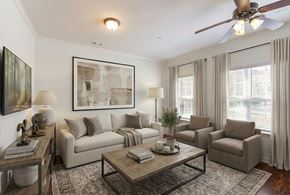 Cordova apartment for rent - A living room with a couch, chairs, a coffee table, and a ceiling fan.