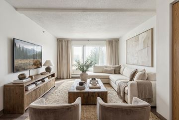 Billings apartment for rent - A living room with a large couch, a coffee table, and a painting on the wall.