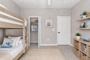 Fort Myers apartment for rent - A bedroom with a bunk bed and a toy truck on the shelf.