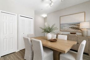 Fort Myers apartment for rent - A dining room with a wooden table and white chairs.