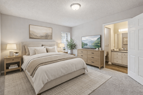 Lithonia apartment for rent - A bedroom with a large bed, a dresser, and a mirror.