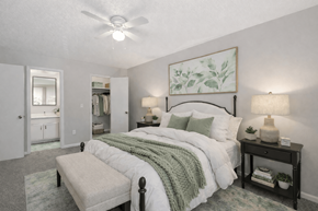 Stone Mountain apartment for rent - A bedroom with a large bed and a ceiling fan.