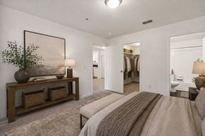 Newnan apartment for rent - A bedroom with a large bed and a painting on the wall.