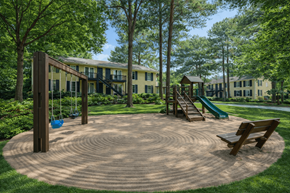 Jonesboro apartment for rent - A playground with a slide, swings and a bench in the middle of a circular sand pit.