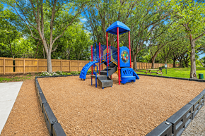 Naples apartment for rent - A playground with a blue and red swing set.