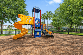 Jacksonville apartment for rent - A playground with a yellow slide and a blue tower.