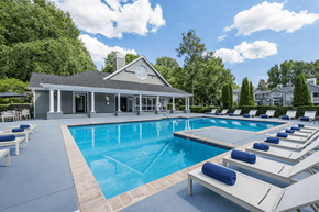 Charlotte apartment for rent - A pool with sun loungers and a house in the background.