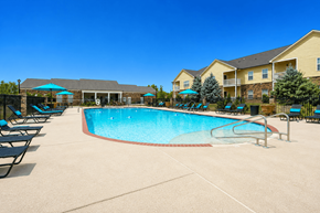 Cordova apartment for rent - A large swimming pool surrounded by lounge chairs and umbrellas.