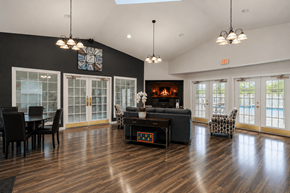Southfield apartment for rent - A living room with a fireplace and a dining table.