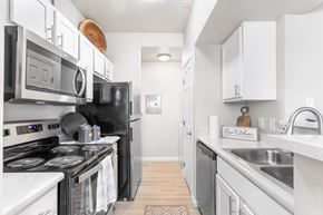 Carson City apartment for rent - a kitchen with stainless steel appliances and white cabinets at Parkway Terraces Apartments, Carson City
