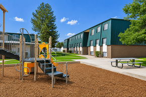 Layton apartment for rent - A playground with a yellow slide and a green building in the background at The Morgan Apartments, Layton