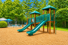Jonesboro apartment for rent - A playground with a green slide and wooden structure.