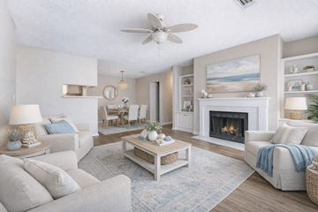 Orange Park apartment for rent - A living room with a fireplace and a painting of a beach scene on the wall.