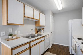West Haven apartment for rent - A kitchen with white cabinets and a white refrigerator at Haven Pointe Apartments, Utah, 84401