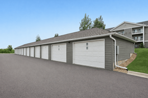 Prior Lake apartment for rent - A long building with a grey roof and white garage doors.
