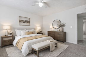 Roswell apartment for rent - A bedroom with a bed, nightstands, and a rug.