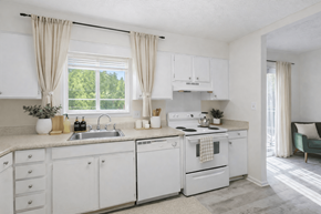 Roswell apartment for rent - A white kitchen with a window and curtains.