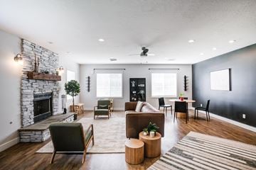 West Haven apartment for rent - the living room has a large stone fireplace and a dining room table and chairs