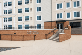 Lino Lakes apartment for rent - Property entrance sign with brick facade at Lakewood Apartments, Lino Lakes