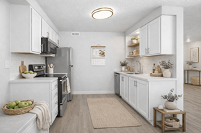 Layton apartment for rent - A kitchen with white cabinets and a refrigerator.