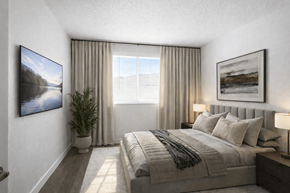 Layton apartment for rent - A bedroom with a large bed and a flat screen TV mounted on the wall.