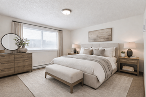Vancouver townhouse for rent - A bedroom with a large bed, a dresser, and a nightstand.