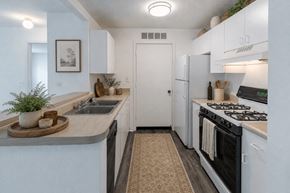 Southfield apartment for rent - A kitchen with a stove, sink, and refrigerator.