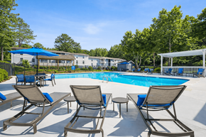 Stone Mountain apartment for rent - A pool surrounded by chairs and trees.