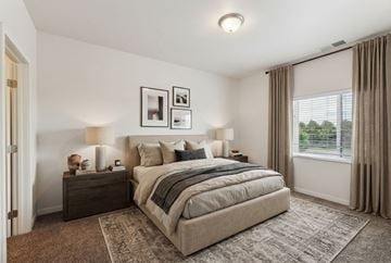 Blaine apartment for rent - A bedroom with a large bed and a window with curtains.