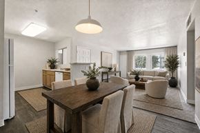 Sacramento apartment for rent - A modern dining room with a wooden table and chairs.