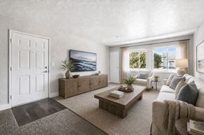 Sacramento apartment for rent - A living room with a large flat screen TV mounted on the wall.