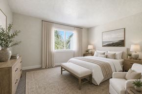 Sacramento apartment for rent - A bedroom with a large bed and a window with curtains.