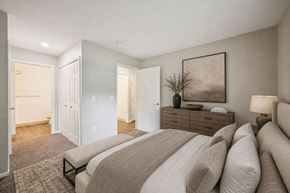 Sterling Heights apartment for rent - A bedroom with a large bed and a painting on the wall.