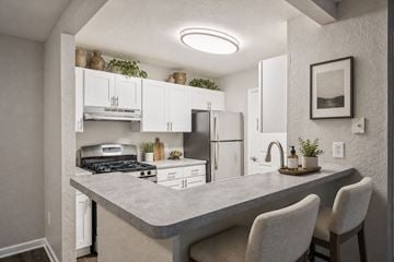 Sterling Heights apartment for rent - A kitchen with a counter and chairs.
