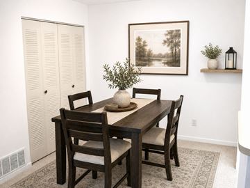 Southfield apartment for rent - A dining room with a wooden table and chairs.
